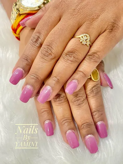 For clients who work a lot on a computer, I often suggest temporary extensions. This set features a lovely mauve gel polish with a simple reverse French glitter accent for a durable and chic look.