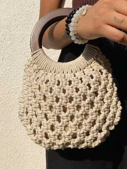 We love the elegant simplicity of this macrame bag with a solid wooden handle. It’s a structured, boho-chic piece that works for brunches, dinners, and everything in between. It also comes with a jute pouch inside to keep your essentials secure.