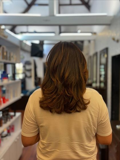 The perfect haircut to beat the heat. This mid-length cut with soft layers is stylish, lightweight, and easy to manage in warmer weather.