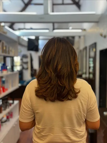 The perfect haircut to beat the heat. This mid-length cut with soft layers is stylish, lightweight, and easy to manage in warmer weather.