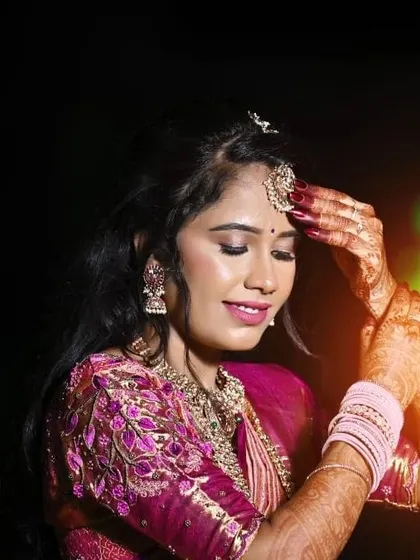 A serene and graceful portrait. The soft, shimmery eyeshadow and glowing skin give her an almost ethereal look, perfect for capturing these precious memories.