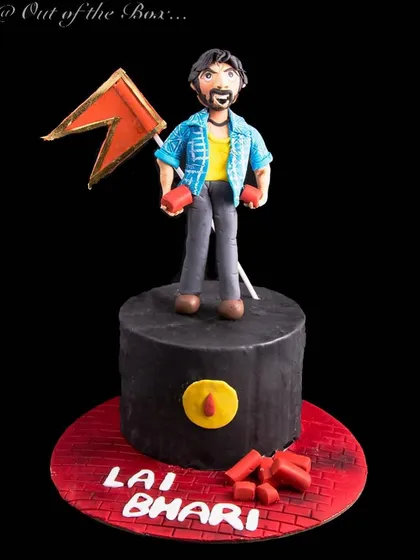 A cake for a fan of actor Ritesh Deshmukh, featuring a fondant figurine inspired by his character in the movie 'Lai Bhari'.