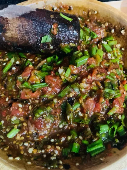 A close-up of a freshly pounded fish chutney, with spring onions and perilla seeds mixed in. This is a staple with any Naga fish thali.