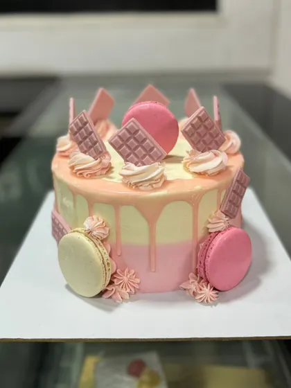 Another view of the pink drip cake with macarons and ruby chocolate.