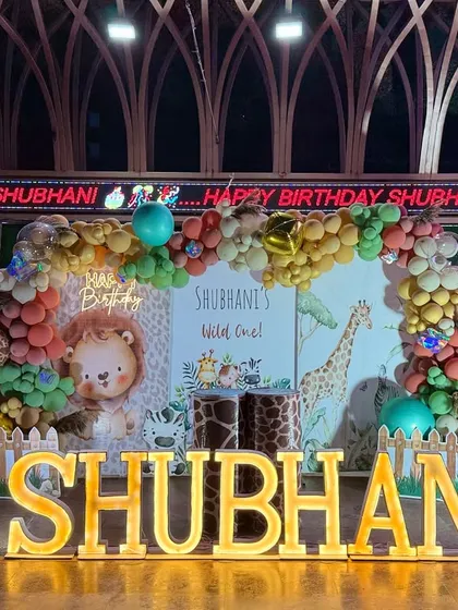 The full stage for Shubhani's wild one birthday, showing how the elements come together, including the venue's digital display which we incorporated into the theme.