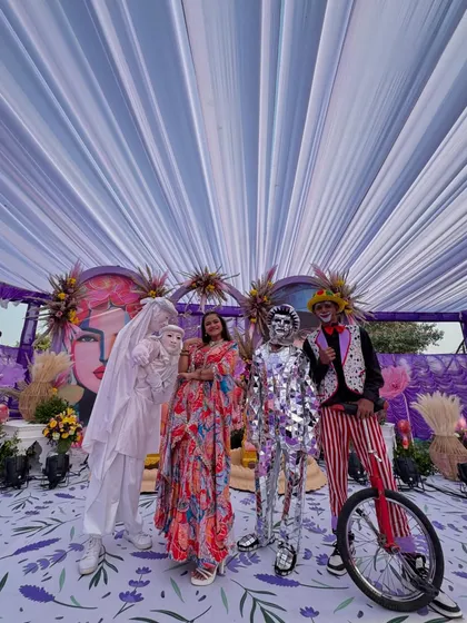 Posing with the carnival performers, who added an extra layer of fun and entertainment to the event.