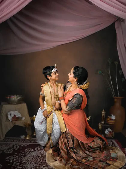 A beautiful, interactive shot of a mother and son looking at each other, captured during their Janmashtami mini-session.
