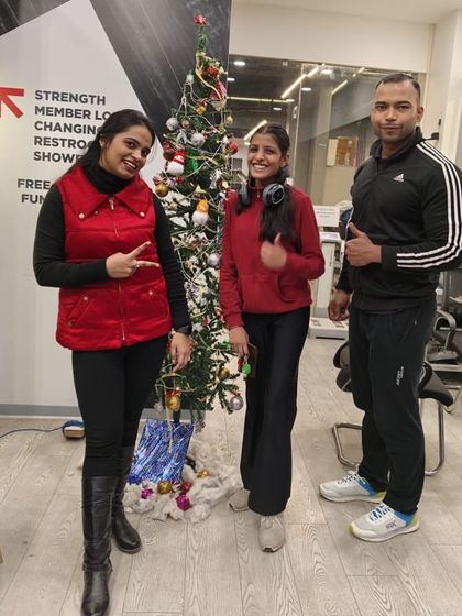 Members and trainers posing by the Christmas tree during our holiday celebration.
