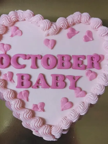 A close-up top view of the "October Baby" bento cake.