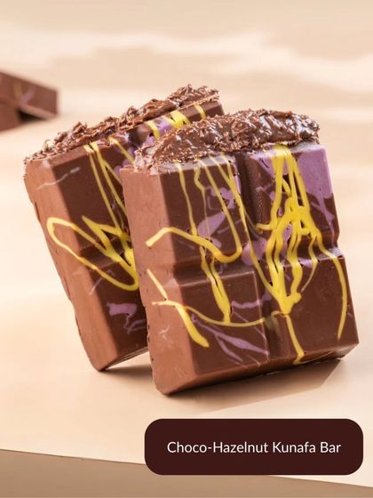 The Choco-Hazelnut Kunafa Bar is a decadent twist on the viral trend. It combines rich chocolate with a gooey hazelnut filling for the ultimate indulgence.