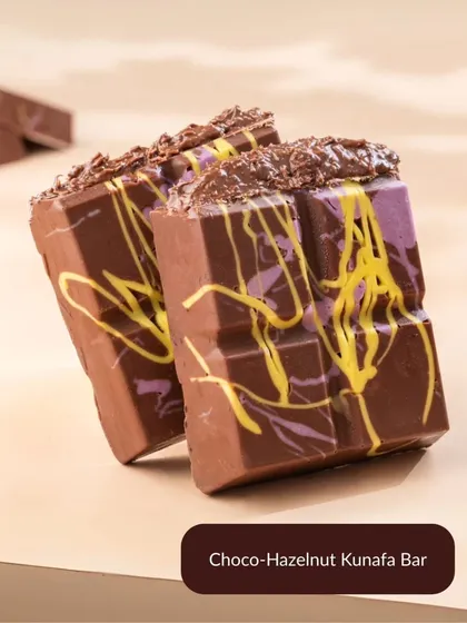 The Choco-Hazelnut Kunafa Bar is a decadent twist on the viral trend. It combines rich chocolate with a gooey hazelnut filling for the ultimate indulgence.