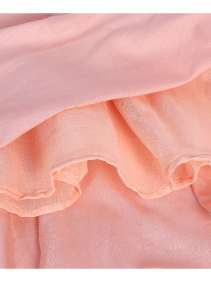 A close-up of the hem and inner fabric of the pink frock.