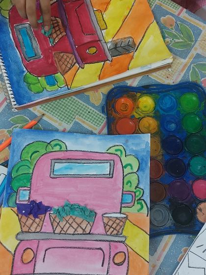 A behind-the-scenes look at our truck painting session. You can see the watercolor palette and the work in progress, full of bright and cheerful colors.