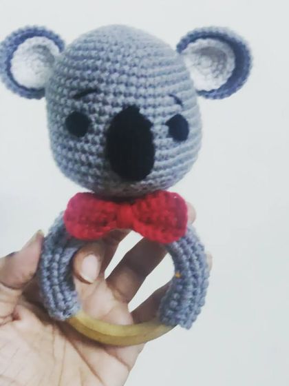 A dapper koala rattle with a little red bow tie. This handmade toy is another great option for a safe, eco-friendly, and adorable baby shower gift.