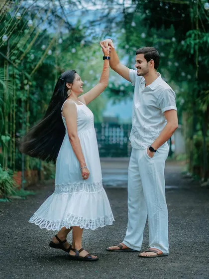 A joyful twirl in a beautiful garden archway. This photo captures the movement of Suchita's dress and the happiness on their faces.