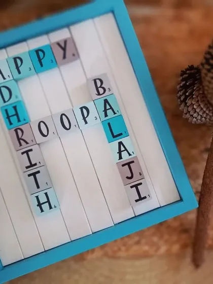 A styled shot of the Scrabble name board, showing how the wooden tiles with family names create a unique and personal piece of wall art.