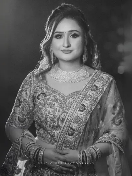A stunning black and white portrait of the bride, Shivani, showcasing her intricate jewelry and elegant makeup.