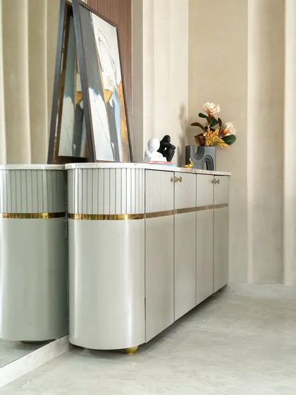 A refined expression of functional beauty, this dining console features a premium PU finish enriched with meticulously carved linear grooves and fine gold strips. The overall effect is one of restrained elegance.