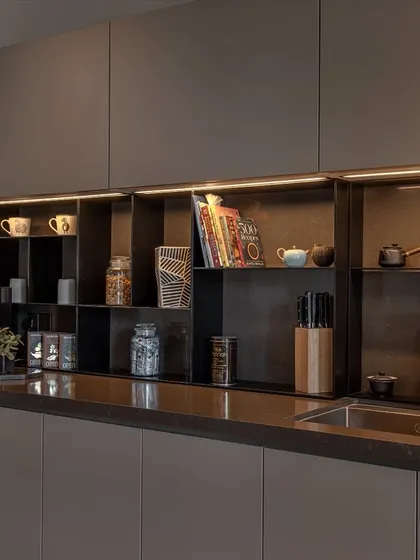 A close-up of the open shelving system. This feature breaks up the solid cabinetry and offers a practical spot for frequently used items, cookbooks, and decor.