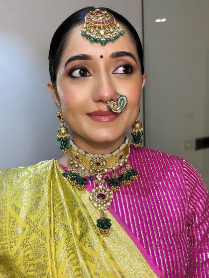 A close-up on Archi's makeup. The subtle winged liner, traditional nath, and statement jewelry come together for a look that is both simple and stunning.