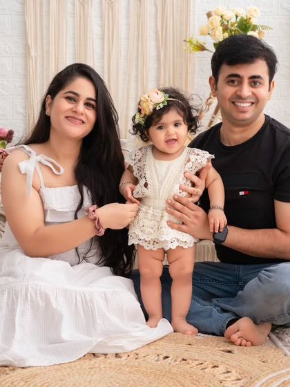 A beautiful family portrait from a boho-themed session. The coordinated white outfits and natural, earthy tones create a light and airy feel.