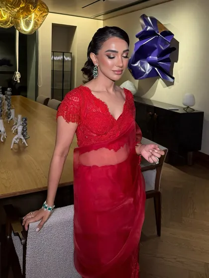 Flawless vibes only. Nayana serving elegance and poise in this red saree. Flawless skin, defined brows, and those bold lips are stunning for an evening event.