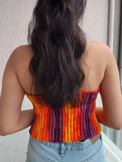 This top can also be worn strapless, showcasing its versatile design.