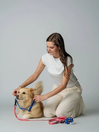 Here, the model is adjusting the harness on the dog, showing how easy the product is to use. This practical, yet gentle moment helps build trust and shows the product in a realistic, caring context.