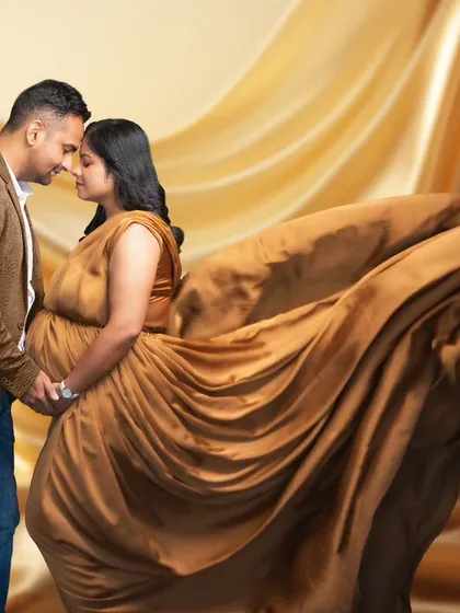 Wrapped in a swirl of golden fabric, their connection is the calm in the center of a beautiful storm. This artistic portrait uses movement and texture to create a dynamic and romantic image.