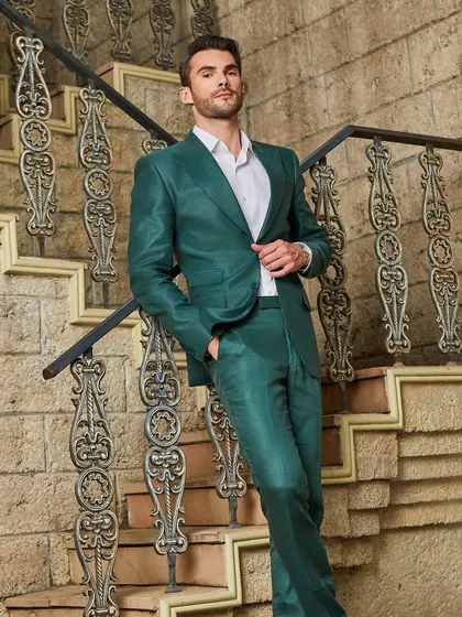 The vibrant green linen suit, seen here on a grand staircase. The sheen of the fabric and the impeccable tailoring create a look of effortless luxury, perfect for a stylish getaway.