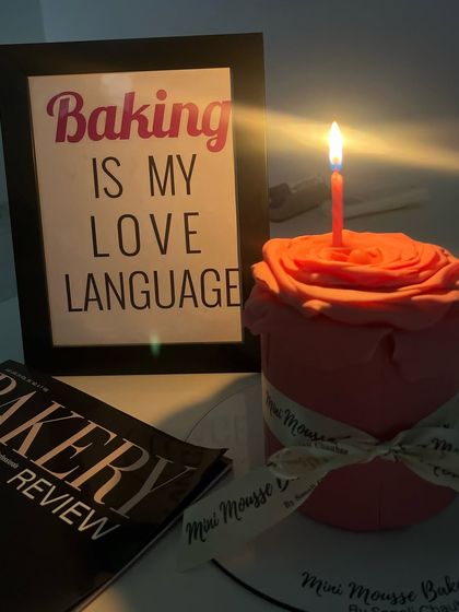 A different kind of floral cake. This one is shaped like a single, large rose, crafted from fondant. It's a beautiful and unique centerpiece.