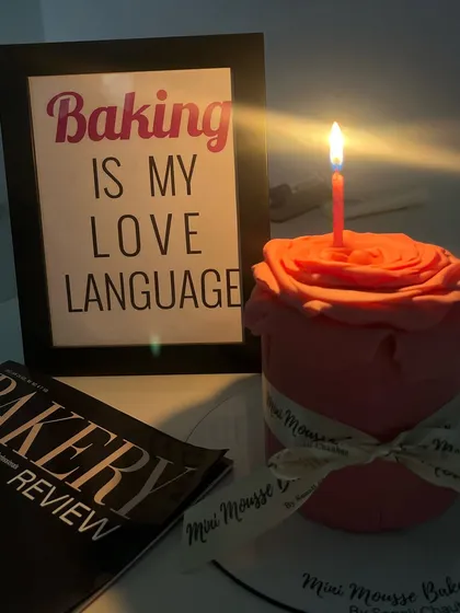A different kind of floral cake. This one is shaped like a single, large rose, crafted from fondant. It's a beautiful and unique centerpiece.