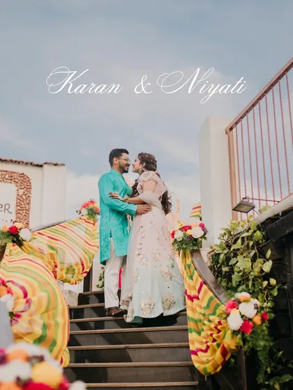 A romantic portrait of the couple on the stairs decorated with colorful drapes for their Haldi carnival. These are the quiet, beautiful moments amidst the grand celebrations.