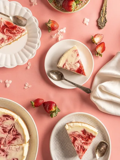 An overhead shot of my Baked Strawberry Cheesecake slices, ready to be enjoyed. The beautiful marble effect from the strawberry compote makes each slice a work of art.