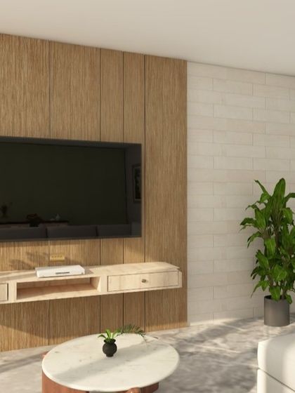 A living room design featuring a TV wall with a combination of louvers, veneer panels, and a brick texture. The floating console keeps the look clean.