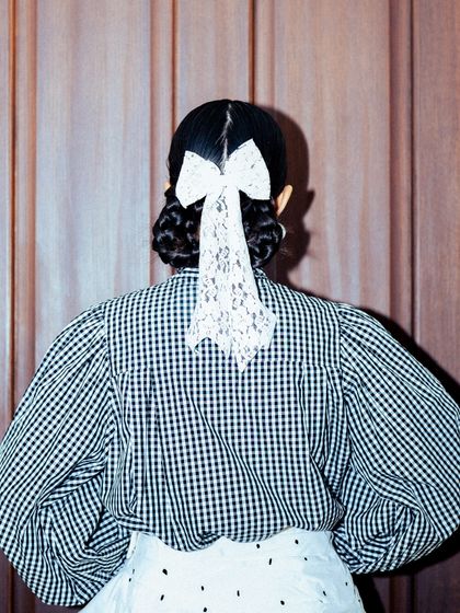 The back view of my GQ Christmas look, focusing on the delicate lace bow in my hair.