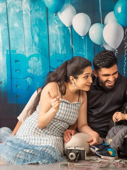 A family moment from a Boss Baby themed shoot, with parents interacting playfully with their son.