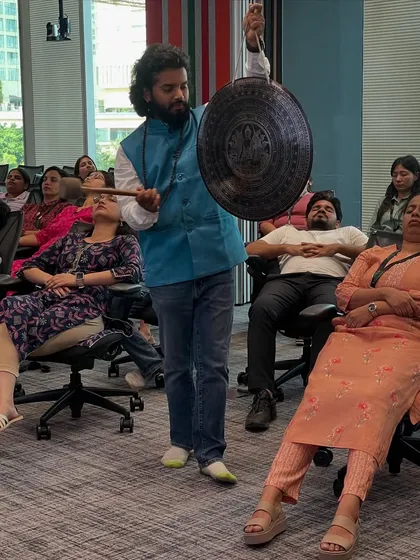 This is the power of a sound bath, right in the workplace. I am using a traditional gong to wash away the stress of the day for the team at 7-Eleven in Bangalore. The vibrations help reset the mind and body, even when you are sitting in an office chair.