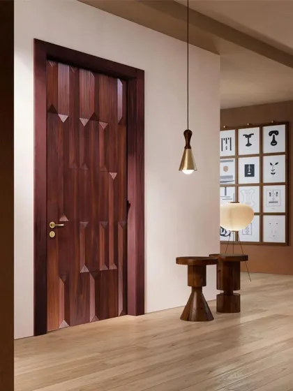 This door, with its deeply carved geometric pattern, adds a sculptural element to the room. It's a perfect example of how a door can be a piece of art in its own right.