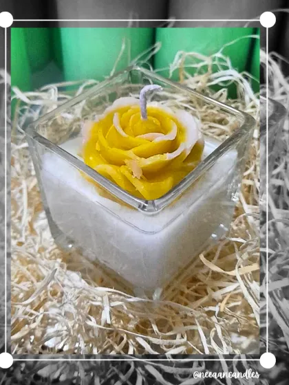 This handcrafted floral soy candle features a beautiful yellow rose in a square glass jar. It's a symbol of warmth, love, and the light your loved ones bring into your life.
