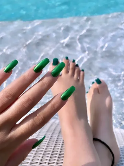 Vacation mode activated. This vibrant, metallic green on long, square nails is the perfect poolside accessory.