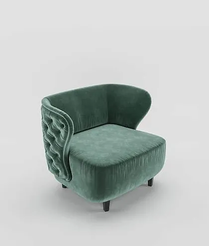 The unique shape of this armchair is evident from this angle, with its curved, tufted back providing both style and support.