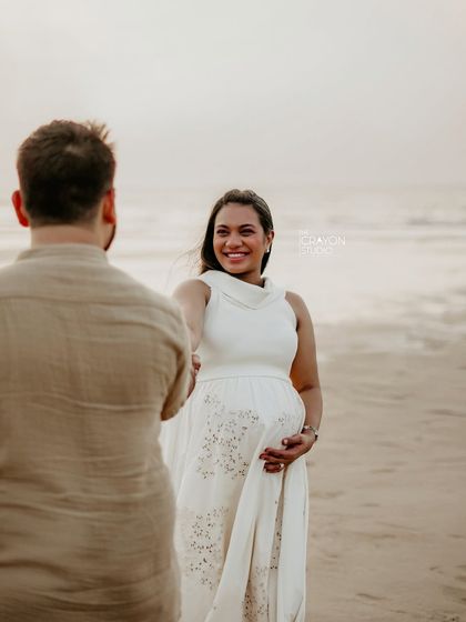 An over the shoulder shot that creates a sense of intimacy and connection. Her bright smile shows the trust and comfort she feels during the session.