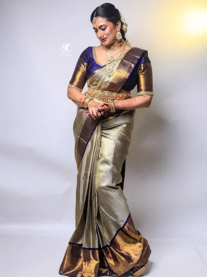 My all-in-one package includes professional saree draping to ensure your Kanjivaram or any other silk saree is pleated and pinned to perfection. This full-length view shows how a perfectly draped saree completes the entire bridal look.