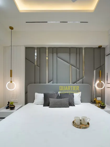 A full view of the guest bedroom at Tata LaVida. The symmetrical design, with matching bedside tables and pendant lights, creates a sense of balance and tranquility. The room is a perfect example of modern, understated luxury.