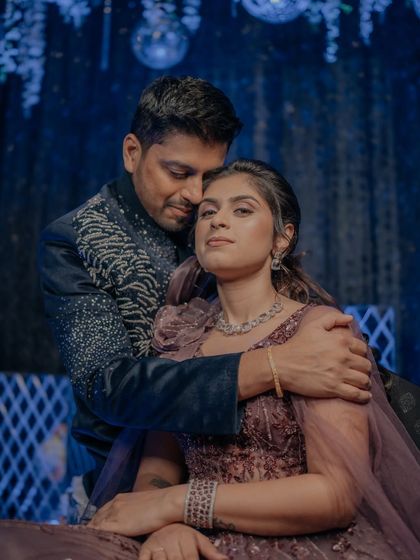 An intimate portrait of the couple during their Sangeet. The groom's embrace and the moody lighting create a romantic and sophisticated feel.