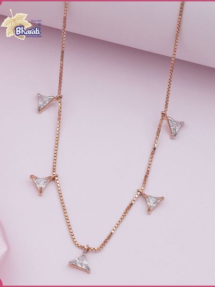 Geometry meets brilliance. This modern necklace features a delicate rose gold chain with sparkling triangle-shaped diamond charms, crafted for everyday luxury.