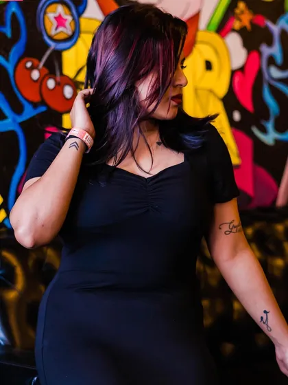 A guest posing against the graffiti wall.