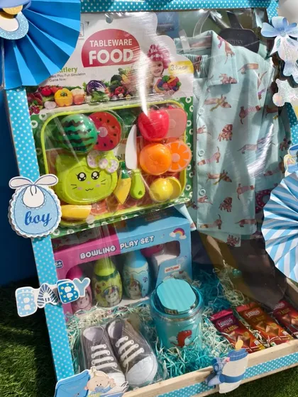 A side view of the birthday hamper, showing the arrangement of toys and clothes.