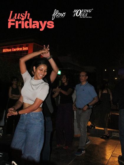 A dancer smiling as she enjoys the music. Whether you come with a partner or solo, you'll always find a welcoming space and friendly faces on the dance floor.